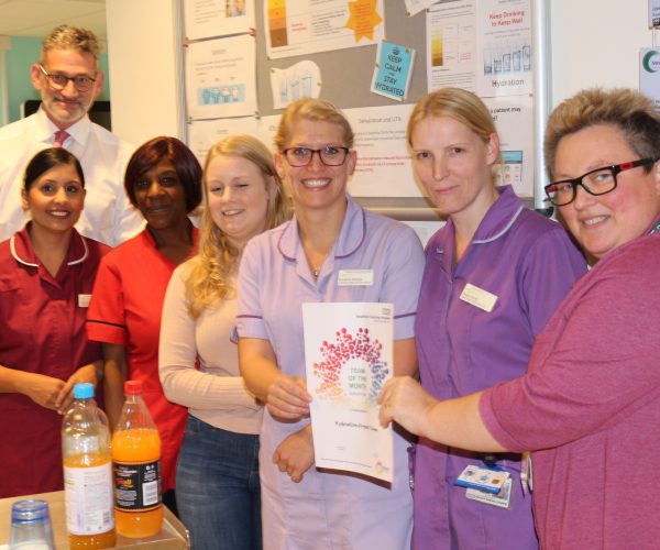 Chief Nurse Karen Dawber (right) presents ward 29 with their Team of the Month certificate