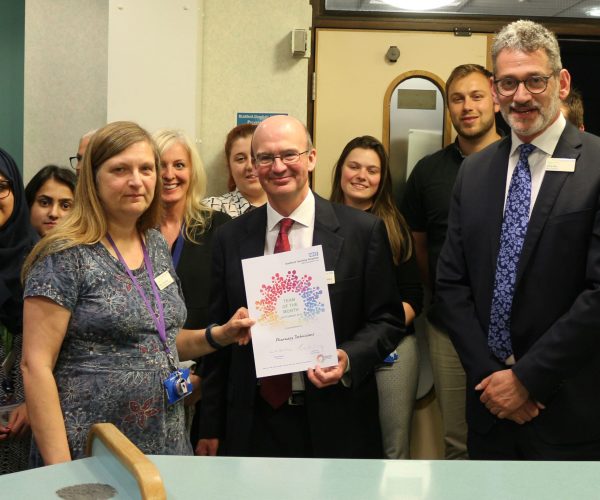 Our pharmacy technicians receive their Team of the Month award from chairman Prof. Bill McCarthy (centre)