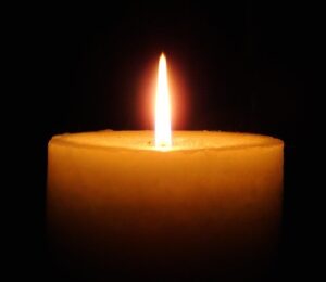 lit candle in the dark